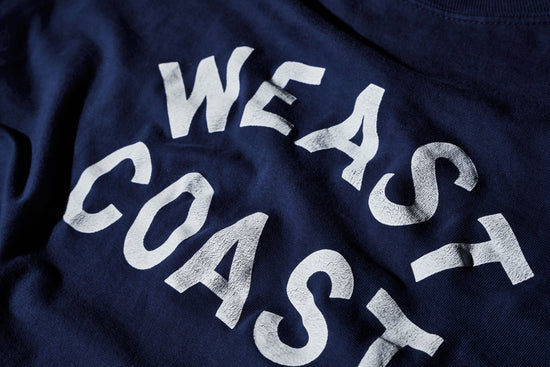 detail of Navy t-shirt with crackle print weast coast arched letters